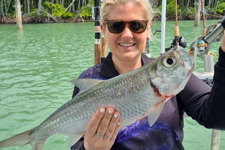 a person holding a fish in the water